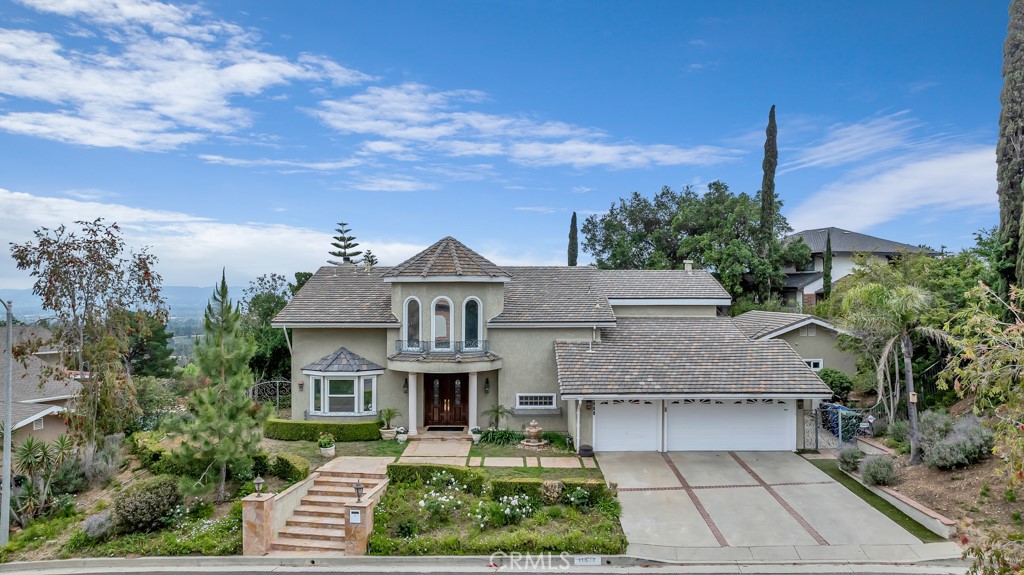 11677 Seminole Circle Porter Ranch, CA 91326 - Photo 3 of 69 a front view of a house with a yard