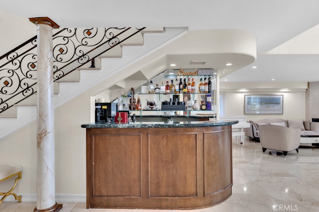 11677 Seminole Circle Porter Ranch, CA 91326 - Photo 47 of 69 a kitchen with stainless steel appliances kitchen island granite countertop a table and chairs in it