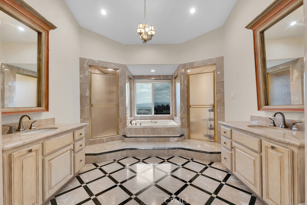 11677 Seminole Circle Porter Ranch, CA 91326 - Photo 52 of 69 a bathroom with a double vanity sink a mirror a vanity and a shower