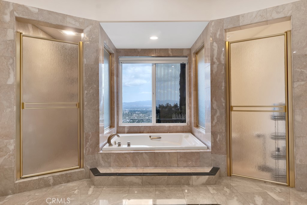 11677 Seminole Circle Porter Ranch, CA 91326 - Photo 53 of 69 a bathroom with a tub and shower