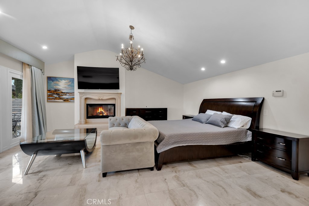 11677 Seminole Circle Porter Ranch, CA 91326 - Photo 54 of 69 a bedroom with bed a flat tv screen and a fireplace