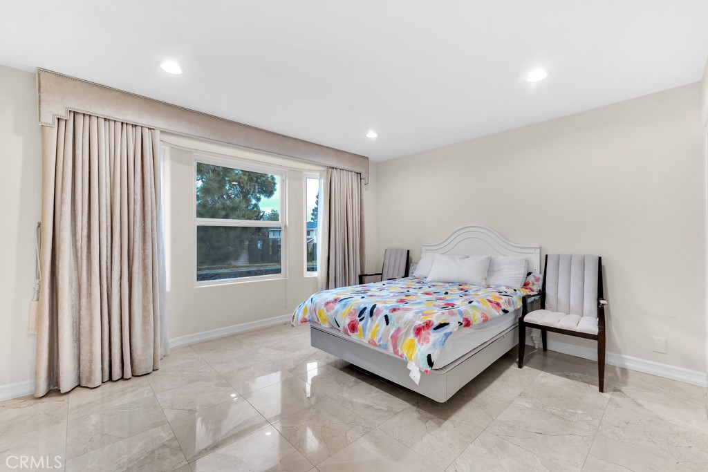 11677 Seminole Circle Porter Ranch, CA 91326 - Photo 60 of 69 a bedroom with a bed lamp and window