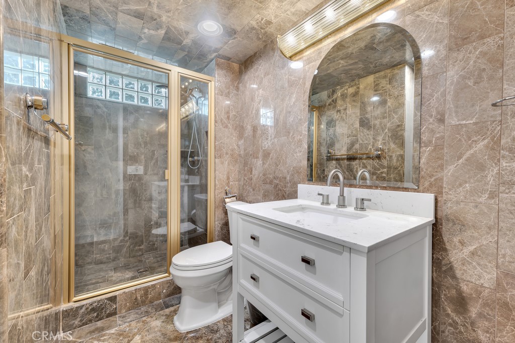 11677 Seminole Circle Porter Ranch, CA 91326 - Photo 64 of 69 a bathroom with a sink toilet a mirror and shower