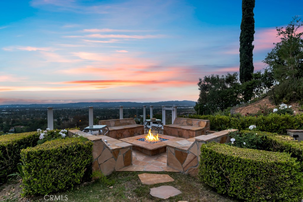 11677 Seminole Circle Porter Ranch, CA 91326 - Photo 10 of 69 a backyard of a house with lots of green space and fountain in the back