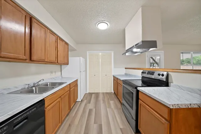 a kitchen that has a sink and a stove