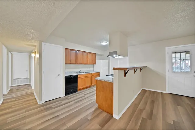 a view of a kitchen cabinets and wooden floor