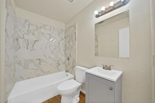 a bathroom with a sink toilet and shower