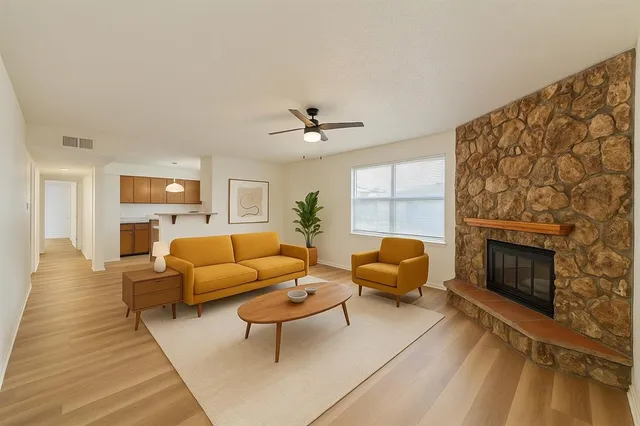 a living room with furniture a fireplace and a flat screen tv
