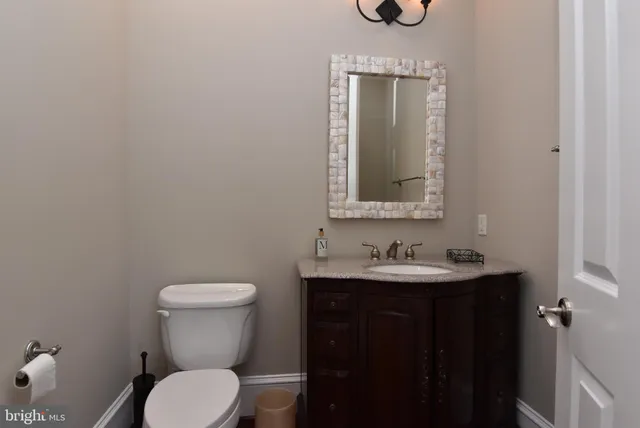 a front view of a house with a yard and potted plants