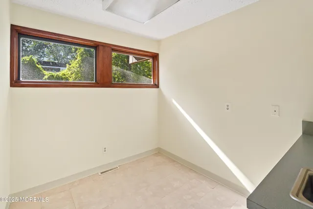 a view of an empty room with windows