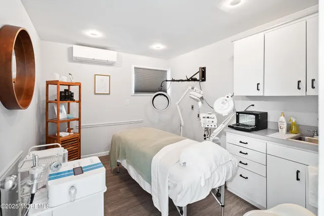 a bedroom with a bed a mirror and dresser