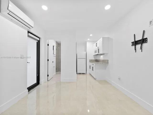 a view of a kitchen with a sink and cabinets