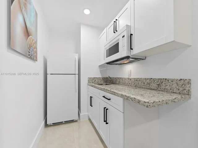 a kitchen with stainless steel appliances granite countertop a sink and a stove