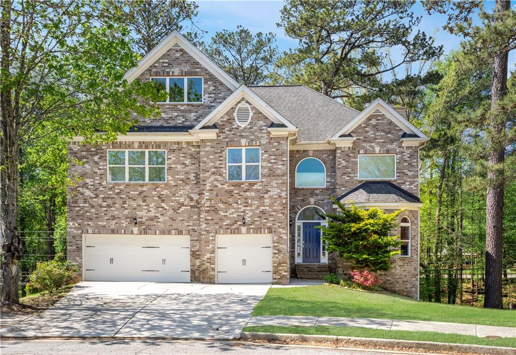 360 Beracah Trail Southwest Atlanta, GA 30331 - Photo 1 of 1 a view of a brick house with a yard plants and large tree