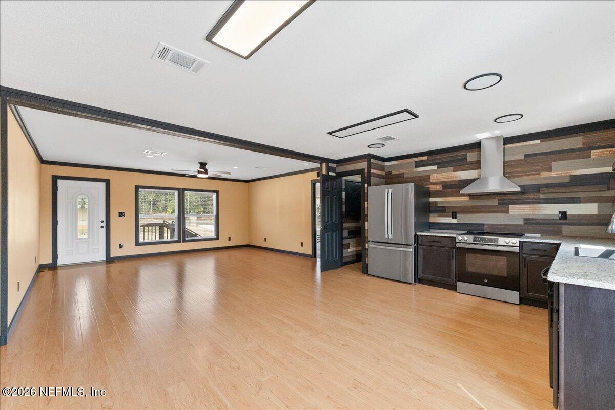 5533 Coronado Street Keystone Heights, FL 32656 - Photo 21 of 73 a view of a kitchen with a stove cabinets and wooden floor