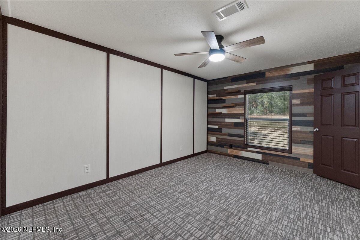 5533 Coronado Street Keystone Heights, FL 32656 - Photo 29 of 73 an empty room with a ceiling fan and a window