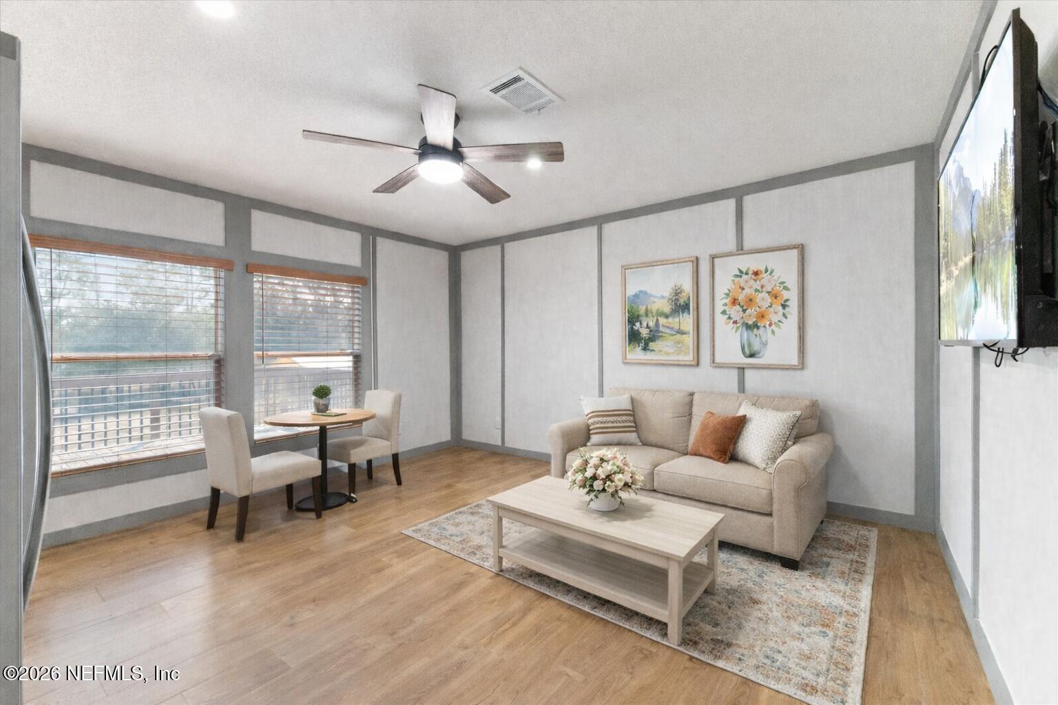 5533 Coronado Street Keystone Heights, FL 32656 - Photo 34 of 73 a living room with furniture and a large window