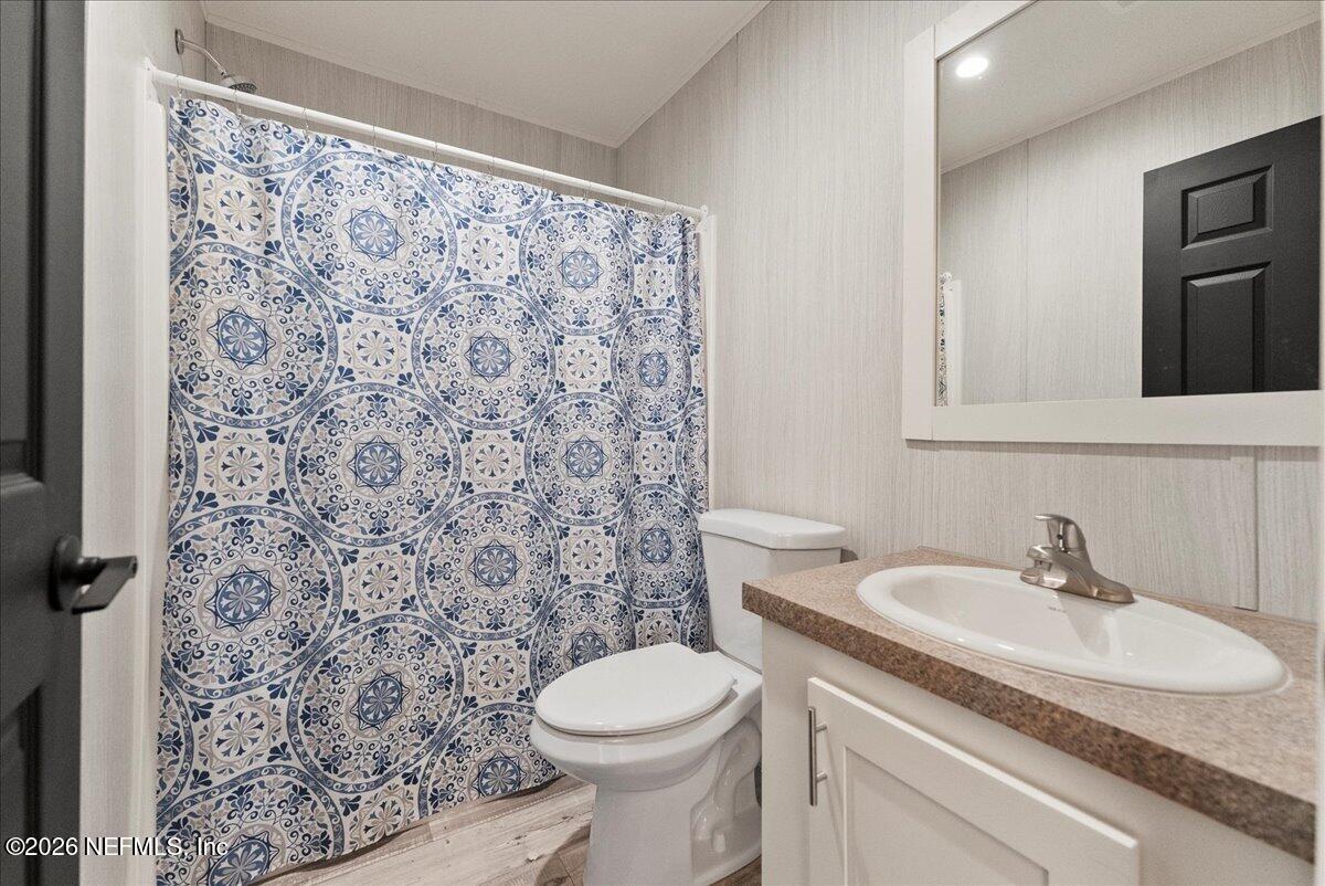 5533 Coronado Street Keystone Heights, FL 32656 - Photo 40 of 73 a bathroom with a sink toilet and a mirror