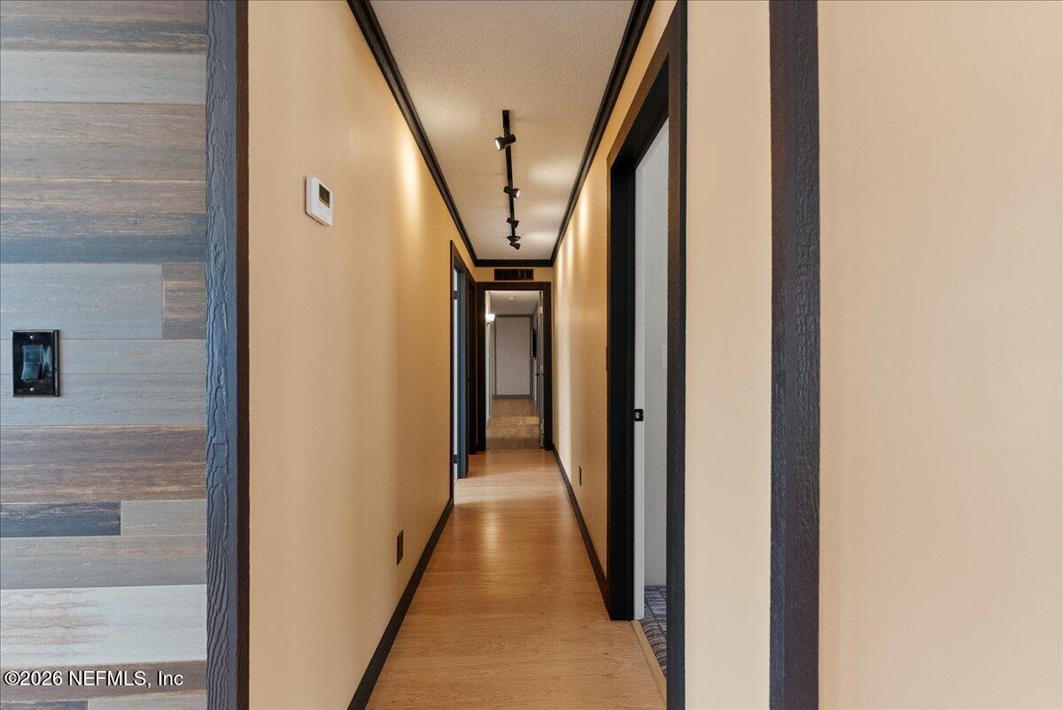 5533 Coronado Street Keystone Heights, FL 32656 - Photo 41 of 73 a view of a hallway with wooden floor and stairs