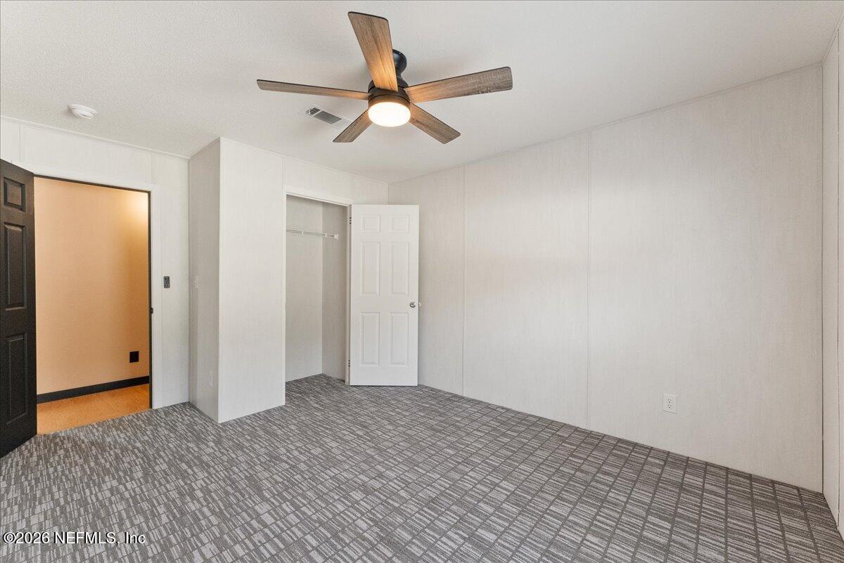 5533 Coronado Street Keystone Heights, FL 32656 - Photo 42 of 73 a view of a livingroom with a ceiling fan and wooden floor