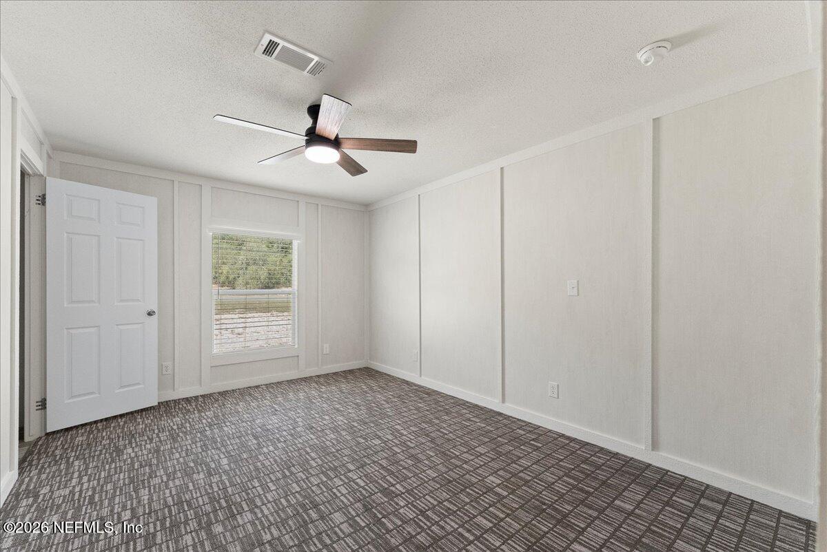 5533 Coronado Street Keystone Heights, FL 32656 - Photo 43 of 73 a view of an empty room and a ceiling fan window