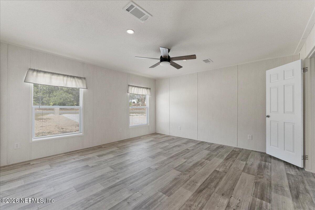 5533 Coronado Street Keystone Heights, FL 32656 - Photo 46 of 73 wooden floor in an empty room with a window