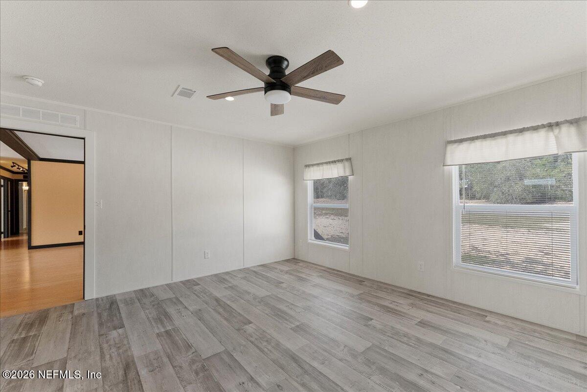 5533 Coronado Street Keystone Heights, FL 32656 - Photo 47 of 73 a view of empty room with wooden floor and fan
