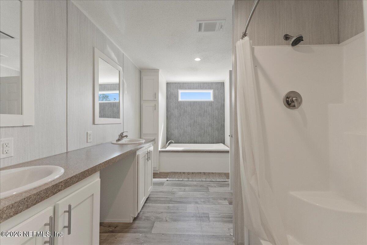 5533 Coronado Street Keystone Heights, FL 32656 - Photo 51 of 73 a bathroom with a granite countertop sink a toilet and shower