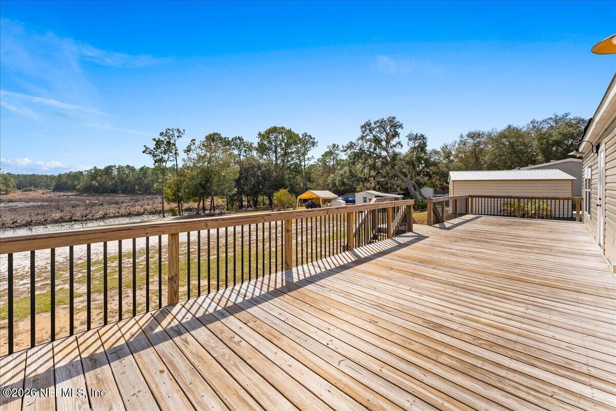 5533 Coronado Street Keystone Heights, FL 32656 - Photo 57 of 73 a balcony with wooden floor and city view