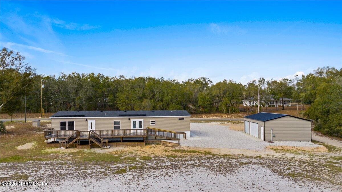 5533 Coronado Street Keystone Heights, FL 32656 - Photo 63 of 73 a backyard of a house with yard and outdoor seating
