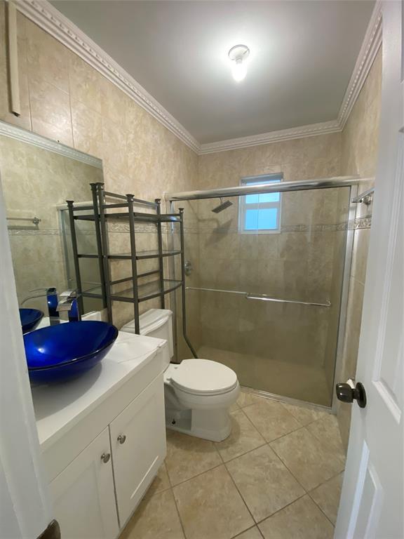 22761 Neptune Road Boca Raton, FL 33428 - Photo 7 of 14 a bathroom with a toilet sink and shower