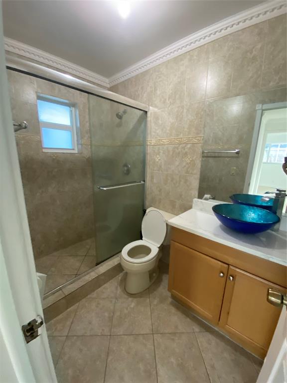 22761 Neptune Road Boca Raton, FL 33428 - Photo 8 of 14 a bathroom with a granite countertop sink toilet and shower