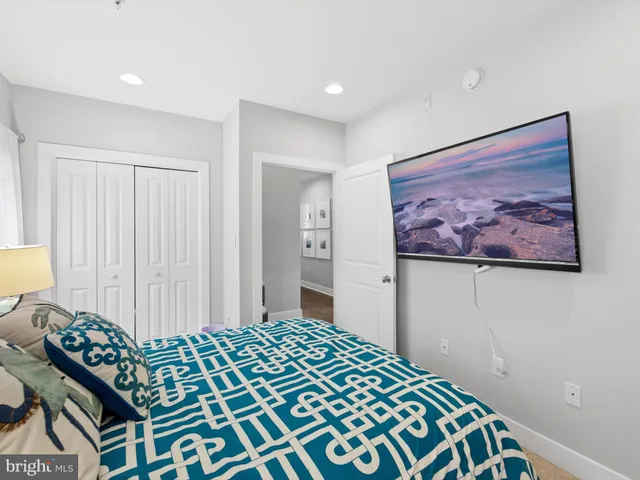 a bedroom with a bed and a painting on the wall