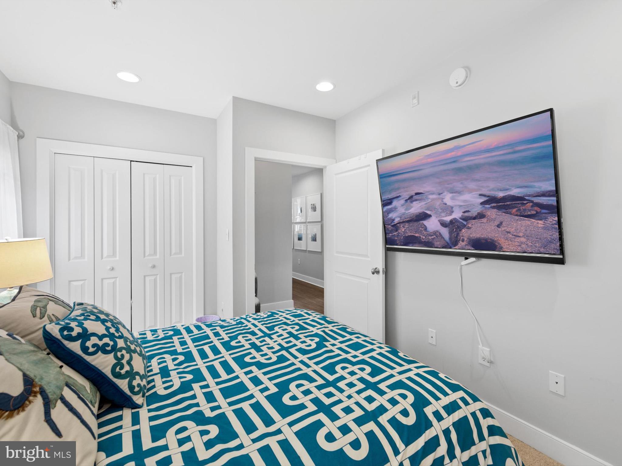 5 87th Street, Unit 303 Ocean City, MD 21842 - Photo 20 of 49 a bedroom with a bed and a painting on the wall