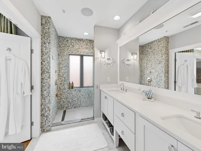a spacious bathroom with double sink and shower