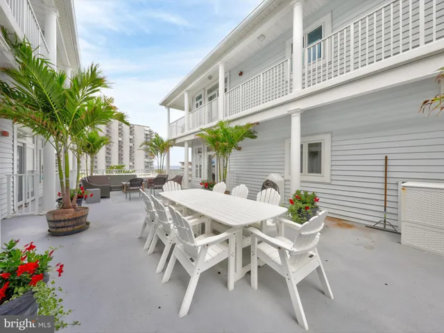 a view of a patio with table and chairs and potted plants