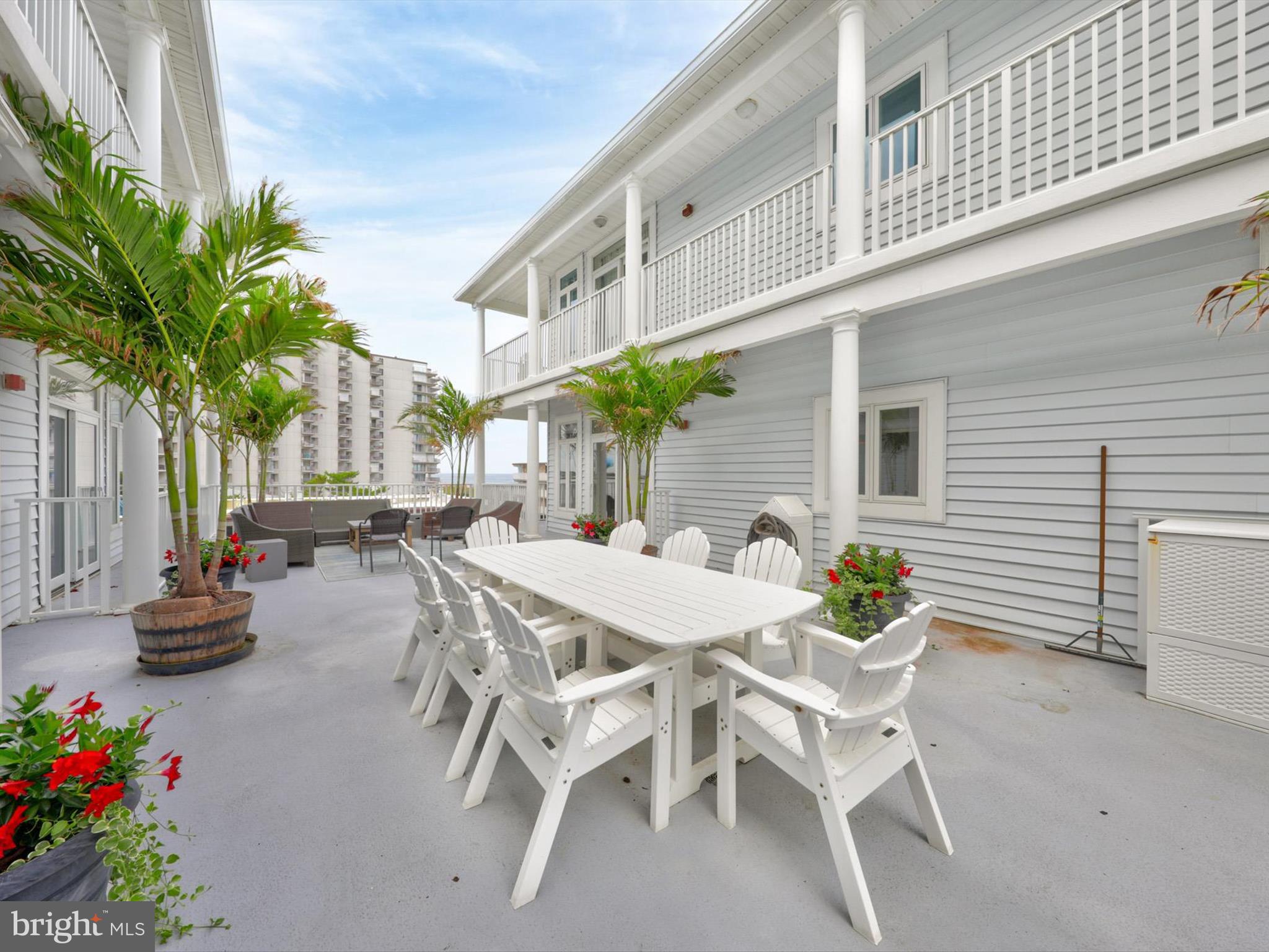 5 87th Street, Unit 303 Ocean City, MD 21842 - Photo 43 of 49 a view of a patio with table and chairs and potted plants