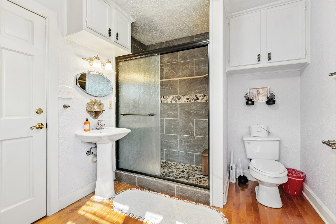 10771 Highway 6 Meridian, TX 76665 - Photo 30 of 40 a bathroom with a sink toilet and shower