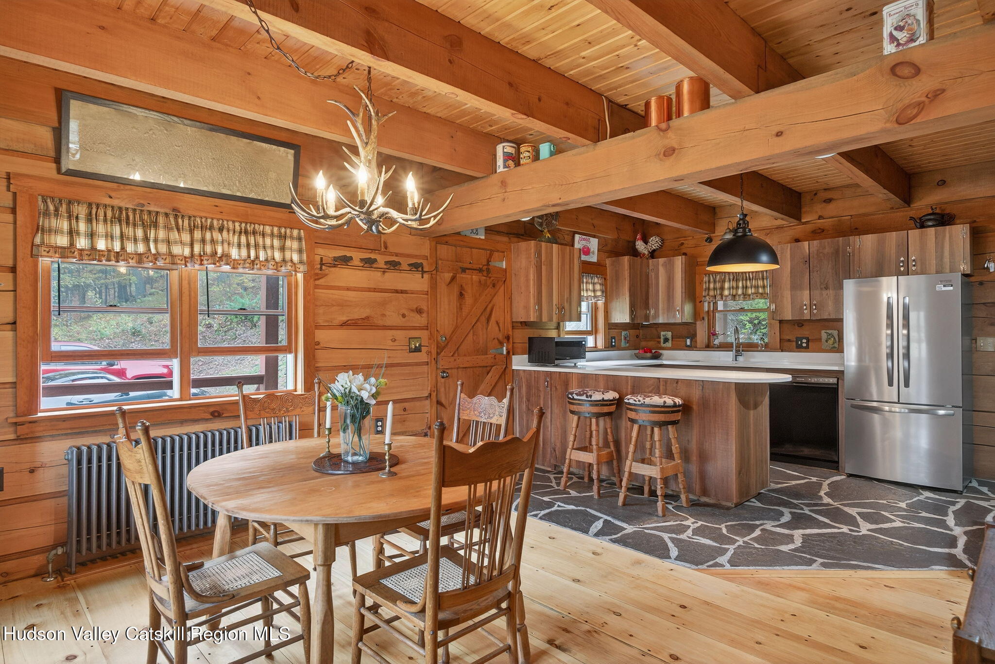 52 Paul Horn Road Catskill, NY 12414 - Photo 9 of 53 a dining room with stainless steel appliances kitchen island granite countertop a table chairs and a wooden floor