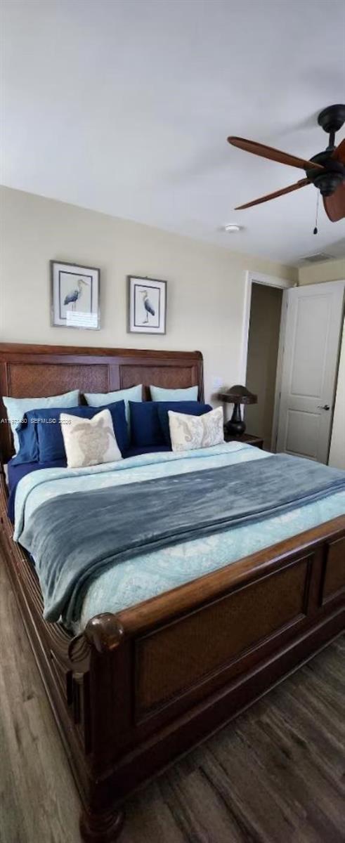 227 Sombrero Beach Road Marathon, FL 33050 - Photo 43 of 56 a bedroom with a bed and wooden floor
