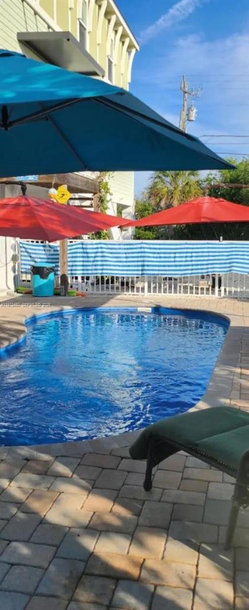 227 Sombrero Beach Road Marathon, FL 33050 - Photo 10 of 56 a view of a swimming pool with an outdoor space and seating area