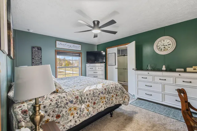 a bedroom with a large bed and a window