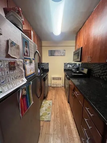 a kitchen with stainless steel appliances granite countertop a stove and a sink