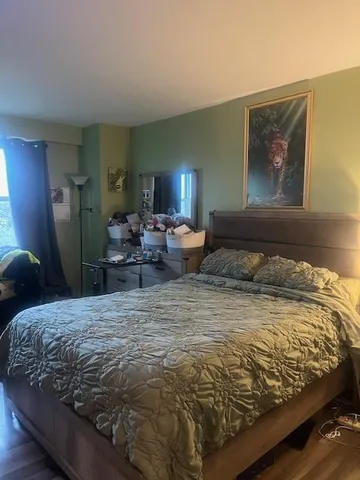 a bedroom with a bed and glass wall