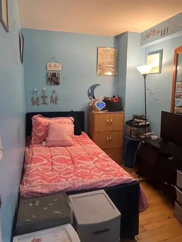 a bedroom with a bed and a desk