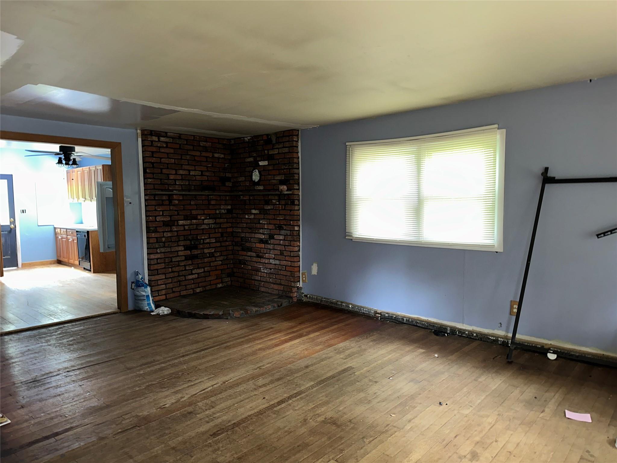77 Lincoln Road Medford, NY 11763 - Photo 4 of 14 an empty room with wooden floor and windows