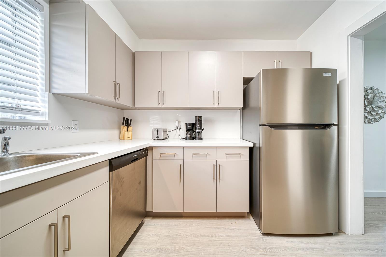 2919 Southwest 25th Terrace Miami, FL 33133 - Photo 22 of 41 a kitchen with a refrigerator sink and cabinets