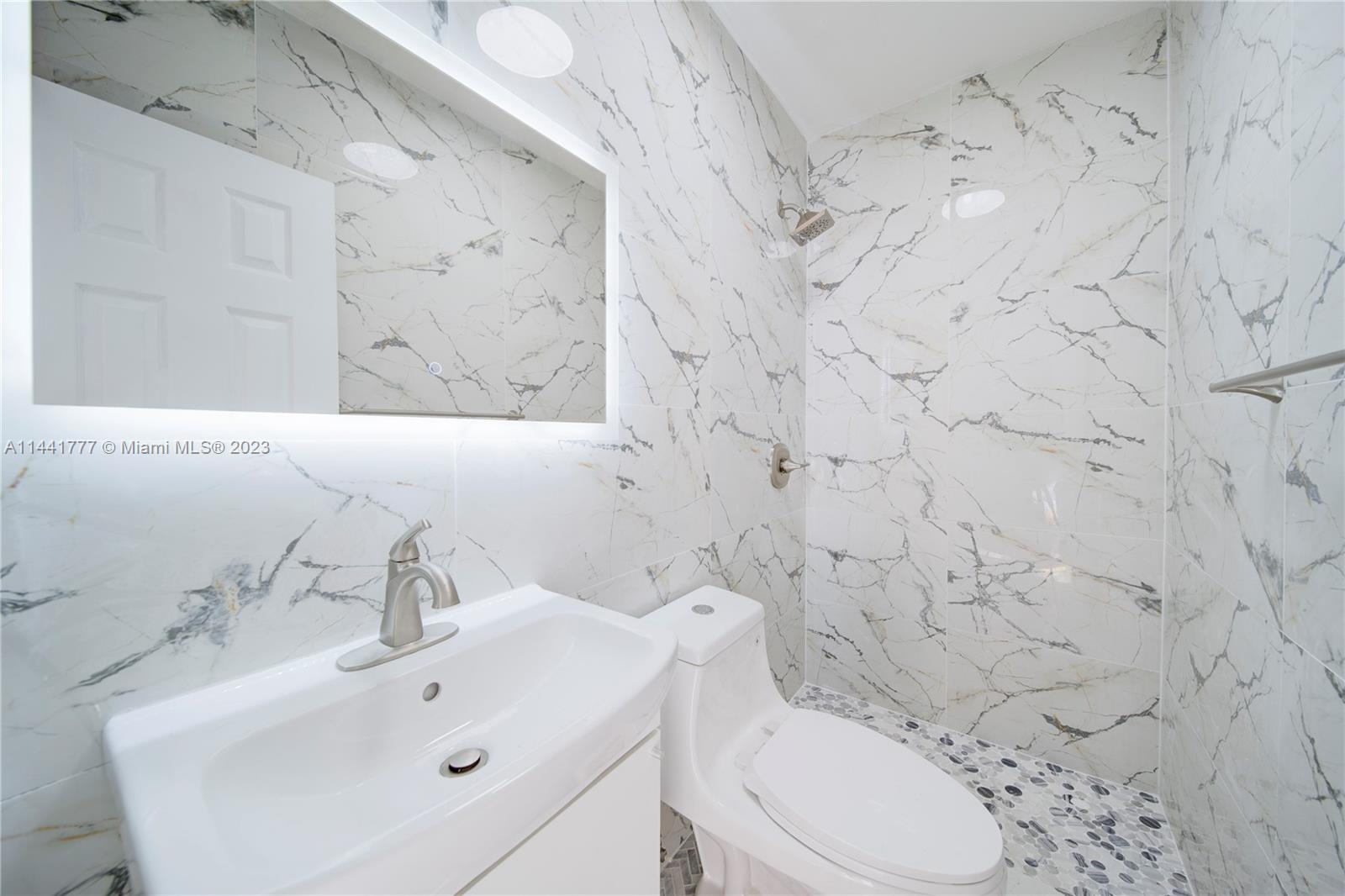 2919 Southwest 25th Terrace Miami, FL 33133 - Photo 5 of 41 a bathroom with a sink toilet and mirror