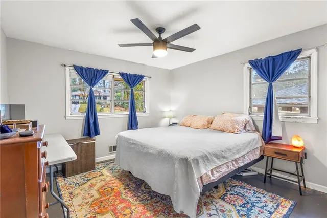 a bedroom with a bed and a table in it with window