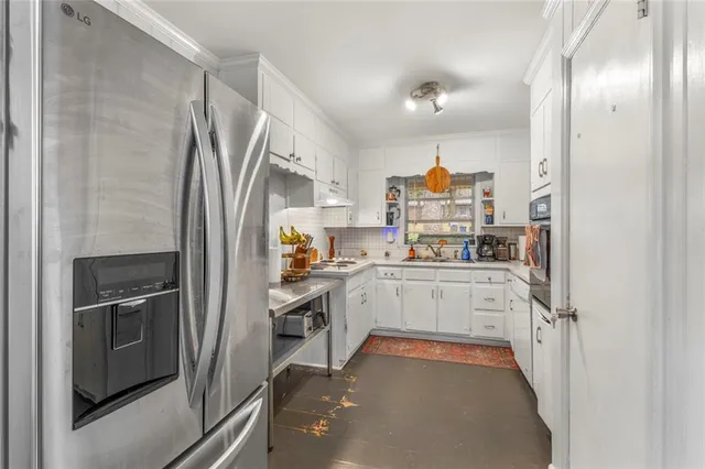 a kitchen with cabinets and stainless steel appliances